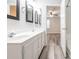 Bathroom featuring dual sinks, a walk-in shower, and wood-look flooring at 1203 Maple Shade Ln, Charlotte, NC 28270
