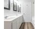 Bathroom featuring dual sinks, a walk-in shower, and wood-look flooring at 1203 Maple Shade Ln, Charlotte, NC 28270