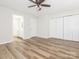 Bright bedroom with wood floors, ceiling fan, and large closet space at 1203 Maple Shade Ln, Charlotte, NC 28270