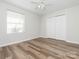 Bedroom featuring wood-look flooring, a ceiling fan, a window with blinds, and a closet with sliding doors at 1203 Maple Shade Ln, Charlotte, NC 28270