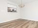 Dining room with wood flooring, modern lighting, and a pass-through window to the kitchen at 1203 Maple Shade Ln, Charlotte, NC 28270