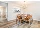 Dining room featuring hardwood floors, modern chandelier and seating for six at 1203 Maple Shade Ln, Charlotte, NC 28270
