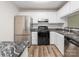 Updated kitchen with stainless steel appliances, black countertops, and white cabinets at 1203 Maple Shade Ln, Charlotte, NC 28270