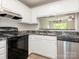 Kitchen with stainless steel appliances, granite counters, a sink, and a pass-through to the dining area at 1203 Maple Shade Ln, Charlotte, NC 28270