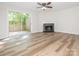 Bright living room with wood floors, fireplace, and sliding glass doors to a deck at 1203 Maple Shade Ln, Charlotte, NC 28270