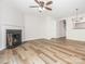 Spacious living room with wood floors, fireplace, ceiling fan and neutral paint at 1203 Maple Shade Ln, Charlotte, NC 28270