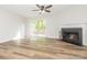 Inviting living room featuring wood floors, a fireplace, and a glass door to the outdoor deck at 1203 Maple Shade Ln, Charlotte, NC 28270