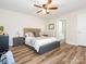 Main bedroom featuring a ceiling fan, neutral walls, and wood-look flooring at 1203 Maple Shade Ln, Charlotte, NC 28270