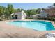A community pool offers clear water, lounge chairs and a nearby building for convenience at 1203 Maple Shade Ln, Charlotte, NC 28270