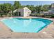 Community pool features crystal clear water, lounge chairs, and a pool house for residents to enjoy at 1203 Maple Shade Ln, Charlotte, NC 28270