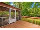 Back porch featuring screened in enclosure and a stained wood railing at 1204 Meadowood Dr, Shelby, NC 28150