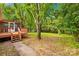 Backyard with a wooden deck, patio, and tree shaded lawn at 1204 Meadowood Dr, Shelby, NC 28150
