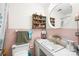 Charming bathroom with tiled walls, a round mirror and a vintage wooden cabinet at 1204 Meadowood Dr, Shelby, NC 28150