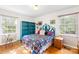 Bright bedroom featuring hardwood floors, a vibrant quilt, and ample natural light at 1204 Meadowood Dr, Shelby, NC 28150