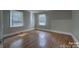Bright bedroom with hardwood floors and two windows that bring in natural light at 1308 Lineberger Ave, Gastonia, NC 28052
