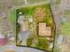 An aerial view of the property showing mature trees, landscaping and large parking area at 132 Larboard Trl, Mount Gilead, NC 27306
