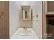 Bathroom features neutral walls, a sink, faucet, mirror, outlets, and towel rack at 132 Larboard Trl, Mount Gilead, NC 27306