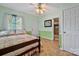 Comfortable bedroom featuring carpet, ceiling fan and soft natural light creating a relaxing ambiance at 132 Larboard Trl, Mount Gilead, NC 27306