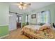 Bedroom with painted green walls, tile floors, natural light and a sliding barn door at 132 Larboard Trl, Mount Gilead, NC 27306