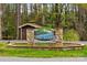 Welcome to Twin Harbor! A beautiful stone sign surrounded by lush greenery and mature trees at 132 Larboard Trl, Mount Gilead, NC 27306