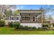 Charming home with a covered porch, dark shutters, and landscaped yard at 132 Larboard Trl, Mount Gilead, NC 27306