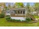 Home with covered porch, a well-maintained lawn, and garden area at 132 Larboard Trl, Mount Gilead, NC 27306