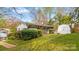 Landscaped yard features a cozy home with covered porch and a well-maintained exterior at 132 Larboard Trl, Mount Gilead, NC 27306
