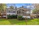 Charming home with a covered porch, dark shutters, and landscaped yard at 132 Larboard Trl, Mount Gilead, NC 27306