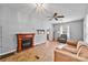Cozy living room with a fireplace, natural light, and a comfortable sofa at 132 Larboard Trl, Mount Gilead, NC 27306