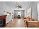 Warm living room featuring a fireplace, a sofa, and neutral wall colors with natural light at 132 Larboard Trl, Mount Gilead, NC 27306
