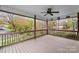 Large, open porch with wooden railing and ceiling fan at 132 Larboard Trl, Mount Gilead, NC 27306