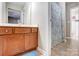 Bright bathroom featuring a wooden vanity, tiled floor, and a shower with curtain at 13610 Aldenbrook Dr, Huntersville, NC 28078
