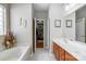Relaxing bathroom with a soaking tub, and a closet at 13610 Aldenbrook Dr, Huntersville, NC 28078