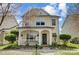 Charming two-story home with a welcoming front porch and beautifully landscaped front yard at 13610 Aldenbrook Dr, Huntersville, NC 28078