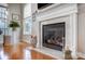 Elegant fireplace with a marble surround, decorative accents, and hardwood floors at 13610 Aldenbrook Dr, Huntersville, NC 28078