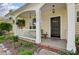 Inviting front porch with seating, hanging plants, and a charming entrance at 13610 Aldenbrook Dr, Huntersville, NC 28078