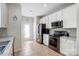 Bright kitchen with stainless steel appliances, white cabinets and granite countertops at 13610 Aldenbrook Dr, Huntersville, NC 28078
