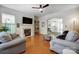 Cozy living room with a fireplace, hardwood floors, and comfortable seating area at 13610 Aldenbrook Dr, Huntersville, NC 28078