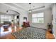 Inviting living room featuring a decorative rug, a red cabinet, and hardwood floors at 13610 Aldenbrook Dr, Huntersville, NC 28078