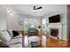 Open living room with hardwood floors, a fireplace, and ample seating at 13610 Aldenbrook Dr, Huntersville, NC 28078