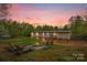 Backyard features a fire pit, seating area, and a home with stairs to enter at 151 Brown Farms Dr, Cleveland, NC 27013