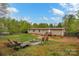 Backyard features a fire pit, seating area, and a home with stairs to enter at 151 Brown Farms Dr, Cleveland, NC 27013