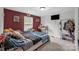 Bedroom features a red accent wall, a window, and a closet for storage at 151 Brown Farms Dr, Cleveland, NC 27013