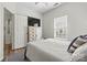 Cozy bedroom featuring light walls, wood floors, a ceiling fan, and a large window for ample natural light at 158 Bluffton Rd, Mooresville, NC 28115