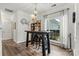 Dining room with hardwood floors, decorative lighting, bar table, and views of the outdoor landscape at 158 Bluffton Rd, Mooresville, NC 28115