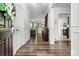 Inviting entryway with hardwood floors and traditional wainscoting detailing leading into the kitchen and living room at 158 Bluffton Rd, Mooresville, NC 28115
