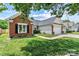 Charming brick and siding home with a well-maintained lawn and attached two-car garage in a desirable neighborhood at 158 Bluffton Rd, Mooresville, NC 28115