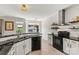 Modern kitchen featuring stainless steel appliances, granite countertops, tiled backsplash, and white cabinetry at 158 Bluffton Rd, Mooresville, NC 28115