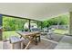 Inviting covered patio with outdoor seating, wooden table, and view of the backyard and storage shed at 158 Bluffton Rd, Mooresville, NC 28115