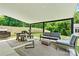 Relaxing covered patio featuring outdoor dining and seating, ideal for enjoying the outdoors in comfort at 158 Bluffton Rd, Mooresville, NC 28115